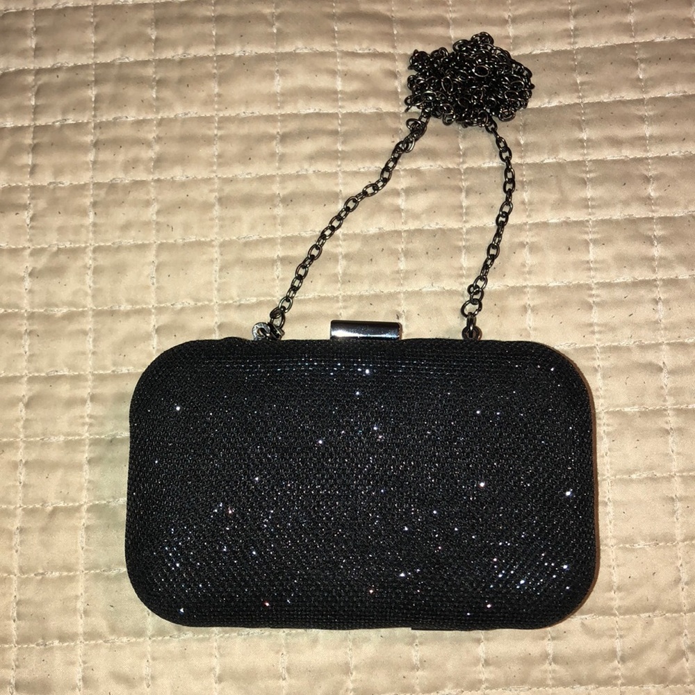 Black and gunmetal accented shimmery clutch. 👜